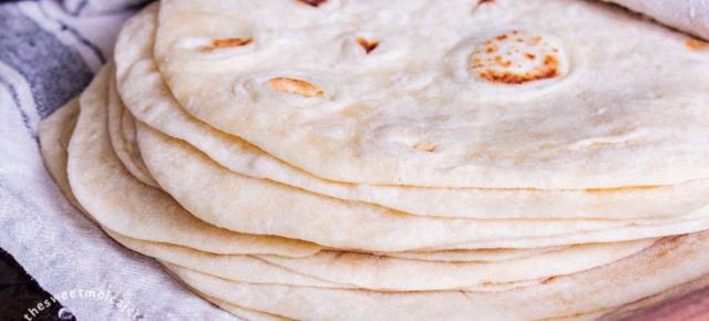 Tortillas de harina cubiertas con una servilleta de lino con un rodillo al frente